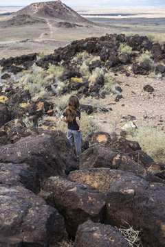 boy exploring an ancient volcano in the desert 