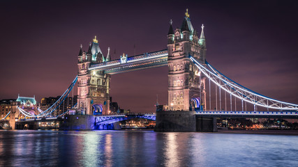 The illuminated Tower Bridge at night, London, UK
