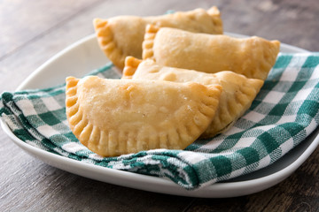 Typical Spanish empanadas on wooden table

