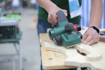 Man hands working with electric planer. Toy and furniture making. Dreaming of future profession. Woodcarving do it yourself lesson. Selfemployment for small business