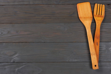 wood spoon on dark wooden background with copy space. Top view.