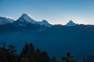 Sunrise over Mount Hood with misty mountains, fog-covered lake, and a serene morning view of snow-capped peaks and forested hills