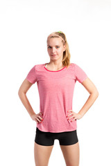 Attractive young fitness woman in red t-shirt. Studio shot.