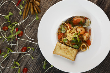 Spaghetti with seafood on wooden  background