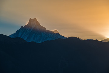 Sunrise over the snowy mountains with a panoramic view of the valley and foggy sky