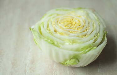 Obraz premium Cut Chinese cabbage stalk on a wooden table. Top view