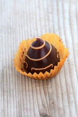 homemade chocolate bonbon close up , wood background