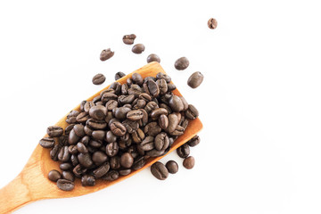 Coffee beans in a wooden ladle on a white background