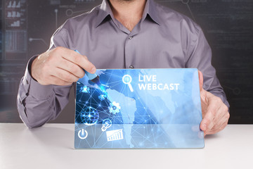 Business, Technology, Internet and network concept. Young businessman working on a virtual screen of the future and sees the inscription: Live webcast