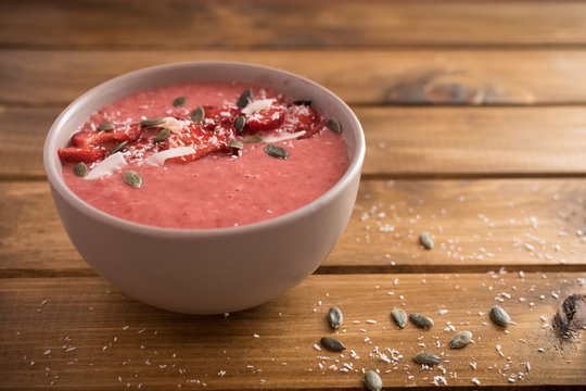 Strawberry, Banana Smoothie In The Bowl. Wooden Background..