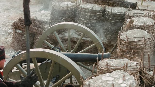 French soldier sets fire to the wick on the cannon
