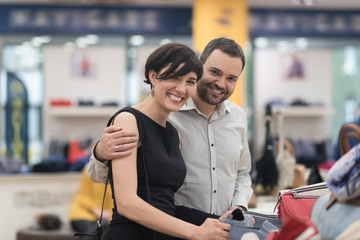 couple chooses shoes At Shoe Store