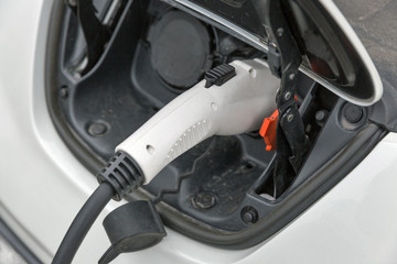 Charging an electric car closeup