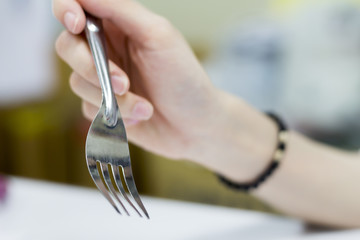People are preparing a fork to eat.