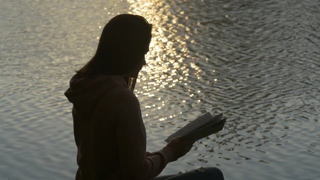 Reading a book on the lake side