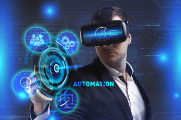 Business, Technology, Internet and network concept. Young businessman working in virtual reality glasses sees the inscription: Automation