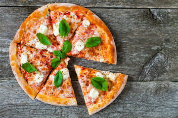 Homemade Pizza with tomato sauce, artichoke hearts, olives, Parmacotto, fresh mozzarella, parmesan...
