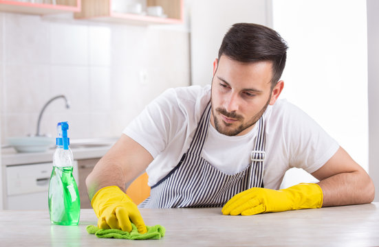 Man Wiping Kitchen Table