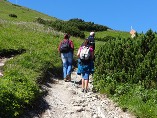 Tourists walk along the hiking trail to the top of Krivan mountain in Mala Fatra, Slovakia