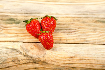 Ripe strawberry on a wooden background
