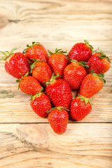 Ripe strawberry on a wooden background