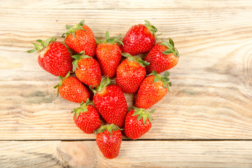 Ripe strawberry on a wooden background