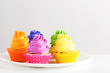 Tasty cupcakes on a white background