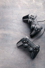 Black joysticks on a grey wooden table © 5second