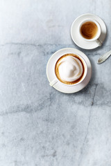 Cup of Cappuccino and a Cup of Espresso on marble background