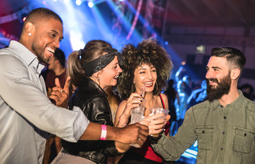 Multiracial young friends dancing at night club - Happy people having crazy fun at nightclub after party - Nightlife drunk concept with afterparty guys and girls celebrating at concert festival event