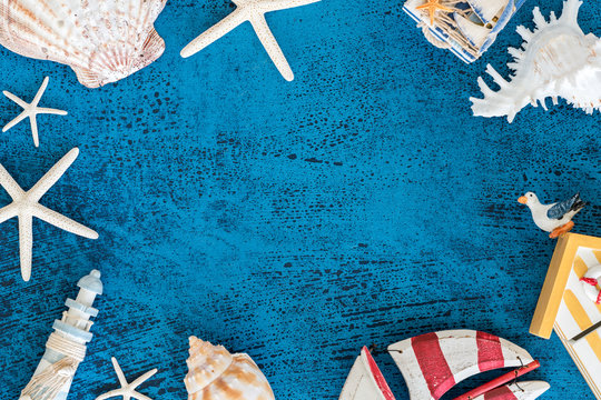 Top view Decorative sailing boats and marine items on wooden background.