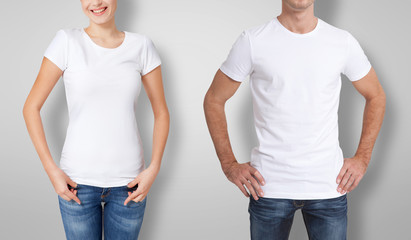 Shirt design and people concept - close up of young man and woman in blank white t-shirt isolated.