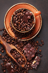 Coffee cup with roasted beans and chocolate