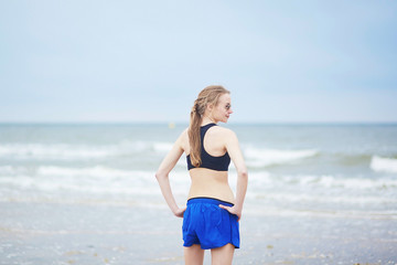 Fototapeta na wymiar Healthy fitness runner girl on beach