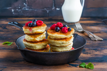 Healthy breakfast, cottage cheese pancakes with raspberry, black currant and blackberry in a...