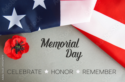 Text Memorial Day on American flag And a poppy flower background