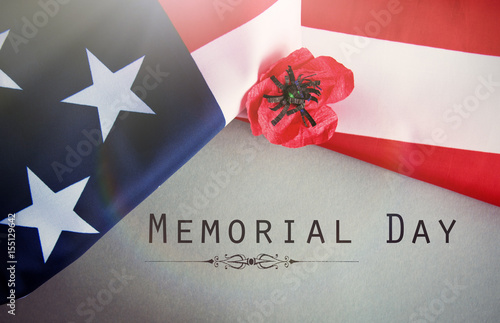 Text Memorial Day on American flag And a poppy flower background