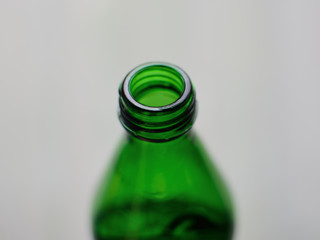 Green bottle neck on a gray background