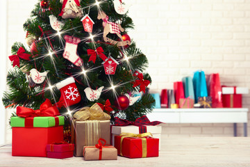 Christmas tree with present boxes in room
