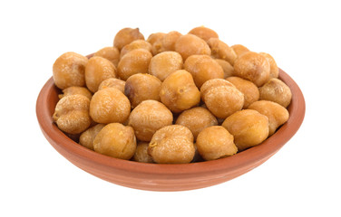 Serving of chickpeas with sea salt in a small red clay bowl isolated on a white background.