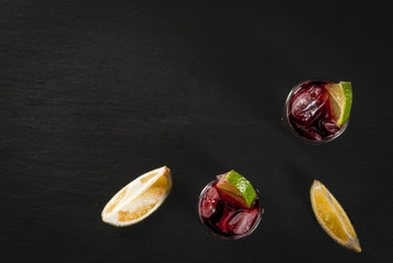 Traditional Spanish alcoholic drink, cocktail, Calimocho. With wine, cola, lime juice and ice. Decorated with pieces of lime. Copy space top view