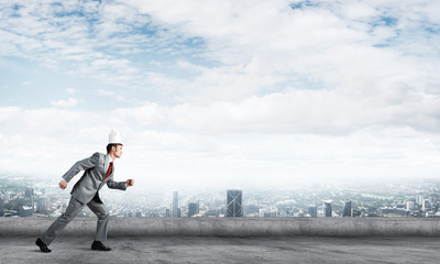 King businessman in elegant suit running on building roof and business center at background