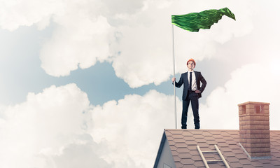 Young businessman with flag presenting concept of leadership. Mi