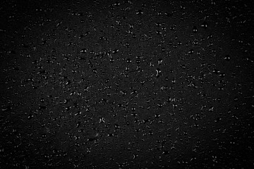 Water drops on dark stone