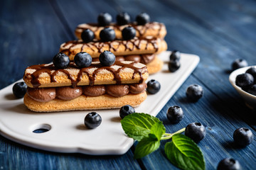 Savoiardi filled with cocoa cream and topped with chocolate and blueberry