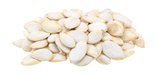 Roasted and salted pumpkin seeds pile isolated on a white background.