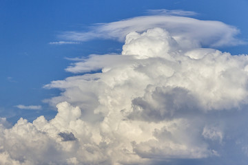 White cumulonimbus cloud on blue sky