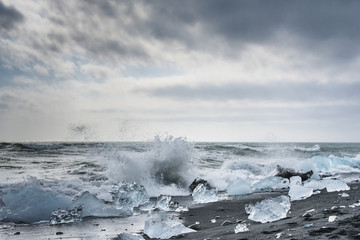 Icebergs on the black send of Atlantic ocean at Jokulsarlon glacial lagoon. Vatnajokull National Park, southeast Iceland