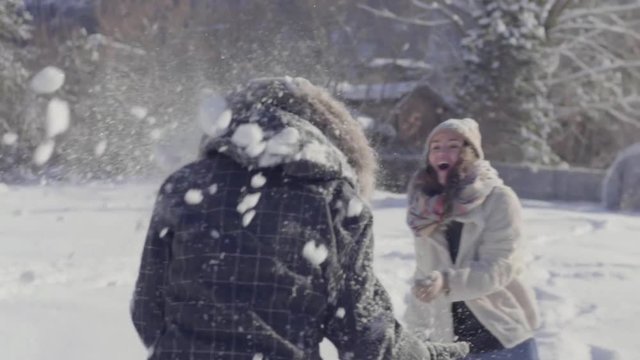 Closeup Of Playful Teens Throwing Snow At Each Other 