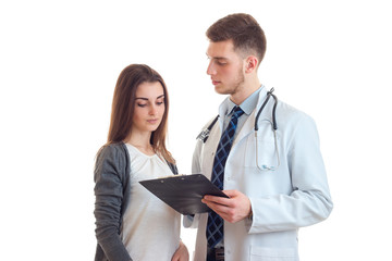 a young doctor in a white coat otherwise shows a beautiful girl with a diagnosis